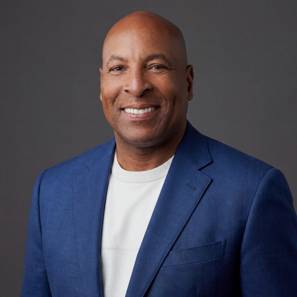 David Grain with telecommunications towers, fiber networks, wireless spectrum graphics, and an executive investment setting.